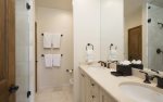 En-suite master bathroom with dual vanity and walk-in shower.